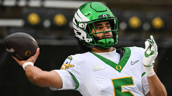 Nov 8, 2025; Iowa City, Iowa, USA; Oregon Ducks quarterback Dante Moore (5) warms up before the game against the Iowa Hawkeyes at Kinnick Stadium. Mandatory Credit: Jeffrey Becker-Imagn Images