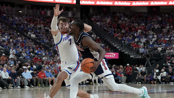 Nov 3, 2025; Las Vegas, NV, USA; Arizona Wildcats guard Jaden Bradley (0) drives against Florida Gators guard Urban Klavzar (7) in the second half of the Hall of Fame Series game at T-Mobile Arena. Mandatory Credit: Candice Ward-Imagn Images