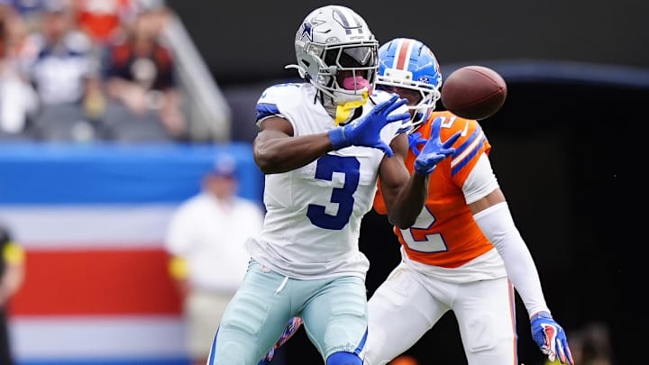 Oct 26, 2025; Denver, Colorado, USA; Dallas Cowboys wide receiver George Pickens (3) makes a catch against Denver Broncos cornerback Pat Surtain II (2) in the second quarter at Empower Field at Mile High. 