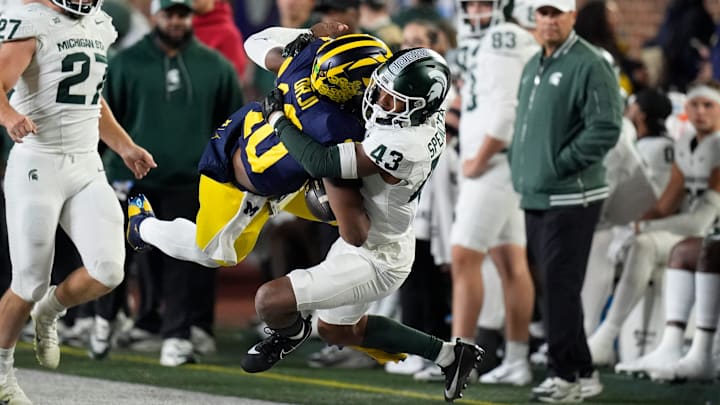 Michigan quarterback Alex Orji (10) is brought down by Michigan State defensive back Malik Spencer (43) during the second half at Michigan Stadium in Ann Arbor on Saturday, Oct. 26, 2024. Michigan quarterback Alex Orji (10) is brought down by Michigan State defensive back Malik Spencer (43) during the second half at Michigan Stadium in Ann Arbor on Saturday, Oct. 26, 2024.