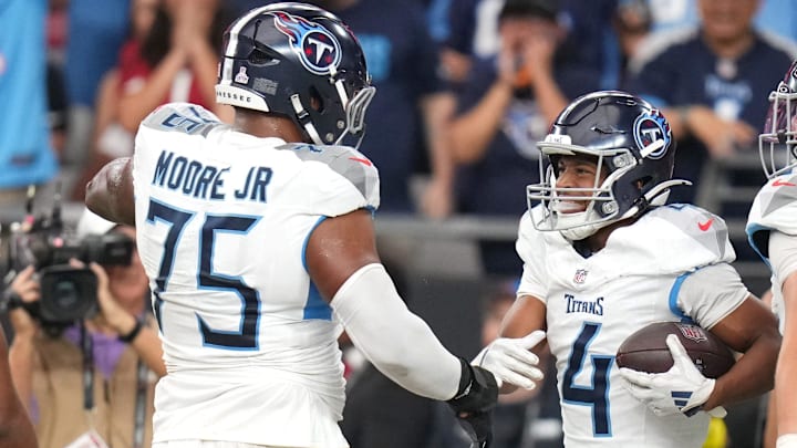 Tennessee Titans receiver Tyler Lockett (4) celebrates with his teammates after falling on a fumble to score a touchdown against the Arizona Cardinals at State Farm Stadium in Glendale on Oct. 5, 2025.