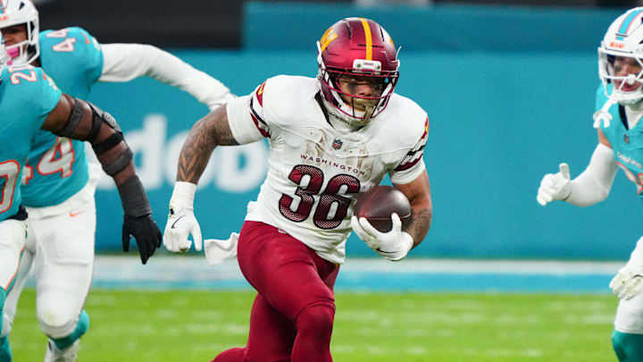 Nov 16, 2025; Madrid, Spain; Washington Commanders running back Chris Rodriguez Jr. (36) carries the ball against the Miami Dolphins in the second quarter during the 2025 NFL Madrid Game at Santiago Bernabeu Stadium. Mandatory Credit: Kirby Lee-Imagn Images