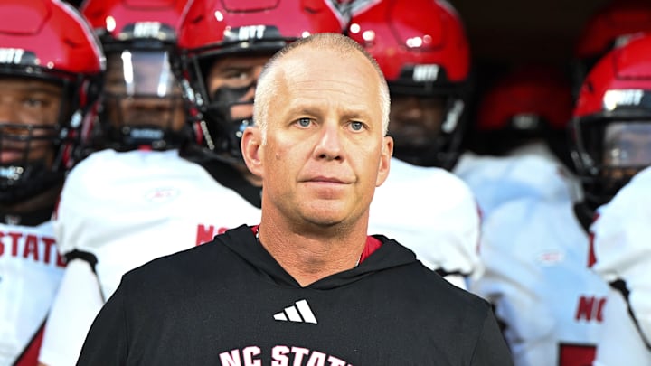 Sep 11, 2025; Winston-Salem, North Carolina, USA;  North Carolina State Wolfpack head coach Dave Doeren walks his team out on the field against the Wake Forest Demon Deacons at Allegacy Federal Credit Union Stadium. Mandatory Credit: Luke Jamroz-Imagn Images
