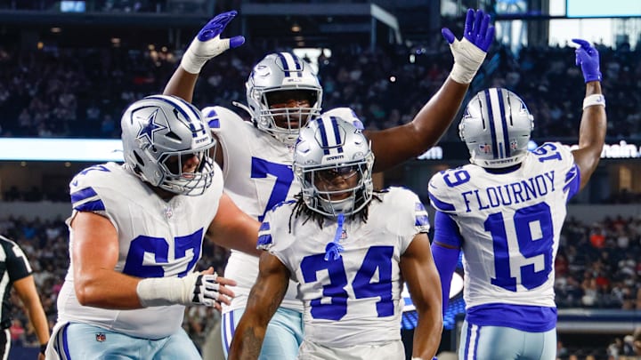 Teammates celebrate with Dallas Cowboys running back Jaydon Blue (34) after he scores a touchdown against the Atlanta Falcons during the first quarter at AT&T Stadium.