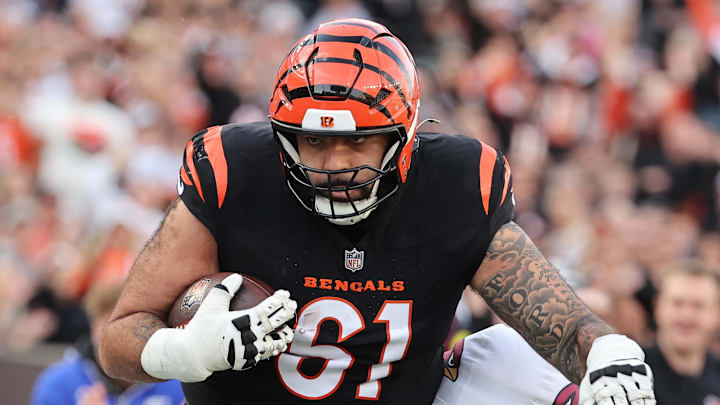 Dec 28, 2025; Cincinnati, Ohio, USA; Cincinnati Bengals guard Cody Ford (61) runs against Arizona Cardinals cornerback Darren Hall (30) and safety Jalen Thompson (34) during the second half at Paycor Stadium. Mandatory Credit: Joseph Maiorana-Imagn Images Dec 28, 2025; Cincinnati, Ohio, USA; Cincinnati Bengals guard Cody Ford (61) runs against Arizona Cardinals cornerback Darren Hall (30) and safety Jalen Thompson (34) during the second half at Paycor Stadium. Mandatory Credit: Joseph Maiorana-Imagn Images