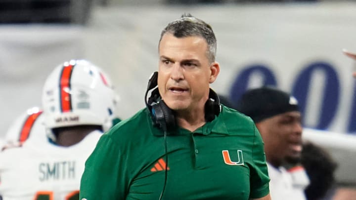 Miami Hurricanes head coach Mario Cristobal reacts beside linebacker Cameron Pruitt (22) during the Cotton Bowl at AT&T Stadium in Arlington, Texas for the College Football Playoff quarterfinal game against the Ohio State Buckeyes on Dec. 31, 2025.