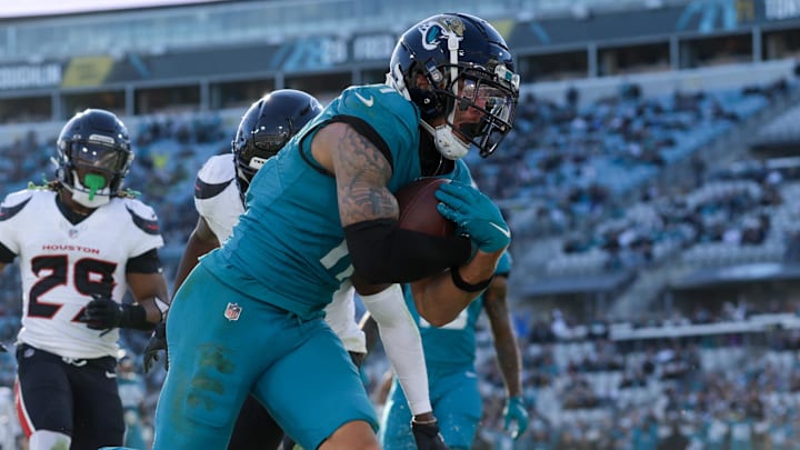Dec 1, 2024; Jacksonville, Florida, USA; Jacksonville Jaguars wide receiver Parker Washington (11) scores a touchdown against the Houston Texans in the fourth quarter at EverBank Stadium. Mandatory Credit: Nathan Ray Seebeck-Imagn Images