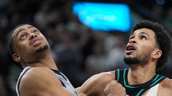 San Antonio Spurs forward/guard Keldon Johnson battles for position with Portland Trail Blazers forward Toumani Camara.