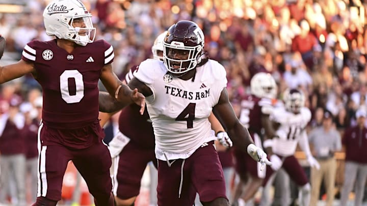Oct 19, 2024; Starkville, Mississippi, USA;Mississippi State Bulldogs quarterback Michael Van Buren Jr. (0) drops back to pass against Texas A&M Aggies defensive lineman Shemar Stewart (4) during the third quarter at Davis Wade Stadium at Scott Field. Mandatory Credit: Matt Bush-Imagn Images
