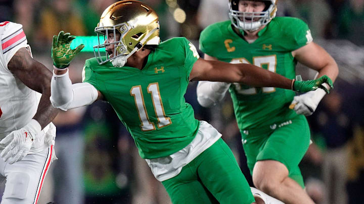 Sep 23, 2023; South Bend, Indiana, USA; Ohio State Buckeyes wide receiver Xavier Johnson (0) heads up field against Notre Dame Fighting Irish safety Ramon Henderson (11) after a catch during the fourth quarter of their game at Notre Dame Stadium.