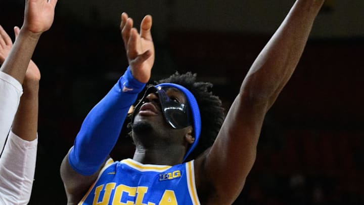 Jan 10, 2025; College Park, Maryland, USA;  UCLA Bruins guard Eric Dailey Jr. (3) takes a shot over Maryland Terrapins center Derik Queen (25) during the first half at Xfinity Center. Mandatory Credit: Reggie Hildred-Imagn Images