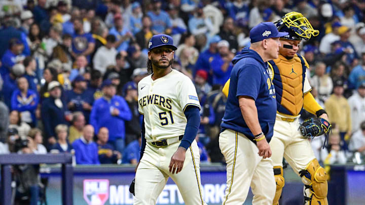 Oct 14, 2025; Milwaukee, Wisconsin, USA; Milwaukee Brewers pitcher Freddy Peralta (51) leaves the mound as he is relieved by manager Pat Murphy (49) in the sixth inning during game two of the NLCS round against the Los Angeles Dodgers for the 2025 MLB playoffs at American Family Field. Mandatory Credit: Benny Sieu-Imagn Images