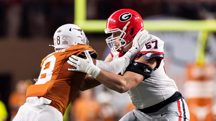 Georgia Bulldogs offensive lineman Monroe Freeling (57) blocks Texas Longhorns edge rusher Trey Moore (8) 