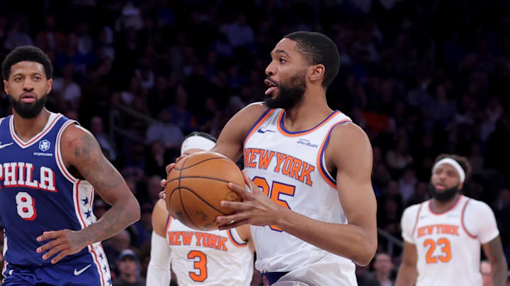 New York Knicks guard Mikal Bridges (25) drives to the basket against Philadelphia 76ers center Andre Drummond (1) and forward Paul George (8) and guard Quentin Grimes (5) during the second quarter of game one of the eastern conference semifinal round of the 2026 NBA Playoffs at Madison Square Garden.