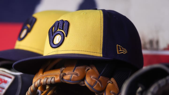 Aug 4, 2025; Atlanta, Georgia, USA; A detailed view of a Milwaukee Brewers hat and glove in the dugout against the Atlanta Braves in the fourth inning at Truist Park. 