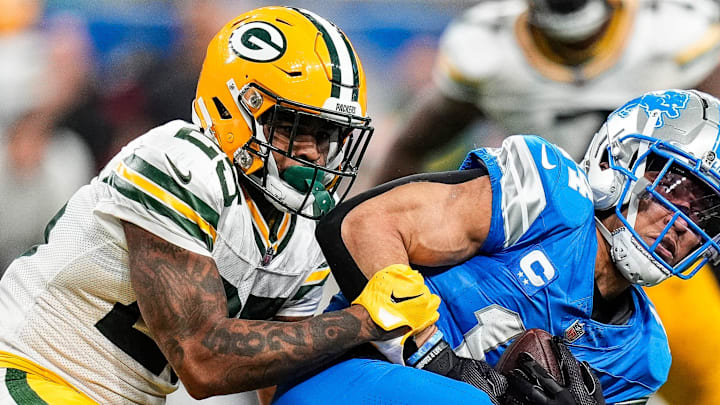 Detroit Lions wide receiver Amon-Ra St. Brown (14) makes a catch against Green Bay Packers cornerback Keisean Nixon.