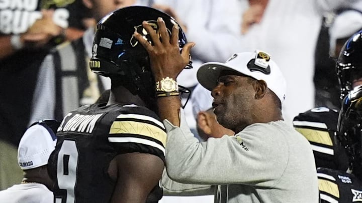 Sep 20, 2025; Boulder, Colorado, USA; Colorado Buffaloes head coach Deion Sanders congratulates wide receiver Sincere Brown (9 )in second quarter at Folsom Field