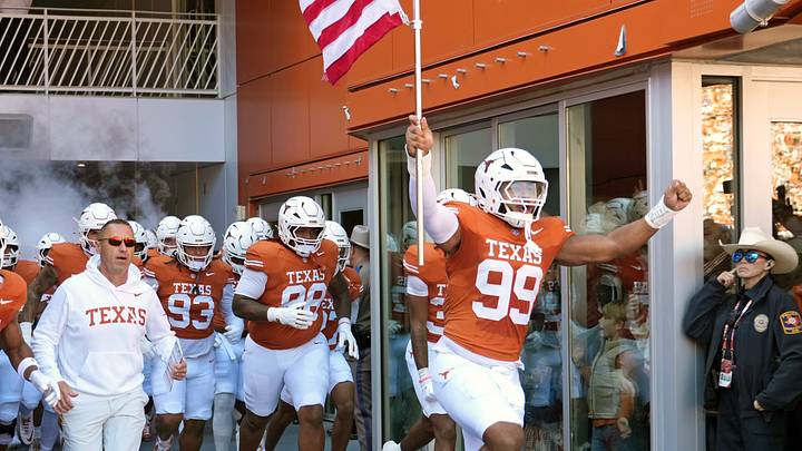 Texas Longhorns Head Coach Steve Sarkisian and players enter the field at Darrell K Royal-Texas Memorial Stadium before a game against the Florida Gators. Texas Longhorns Head Coach Steve Sarkisian and players enter the field at Darrell K Royal-Texas Memorial Stadium before a game against the Florida Gators.