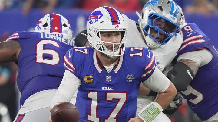 Buffalo Bills quarterback Josh Allen turns and holds out the ball for Buffalo Bills running back James Cook during the Bills home opener game against the Detroit Lions on Sept. 17, 2026.