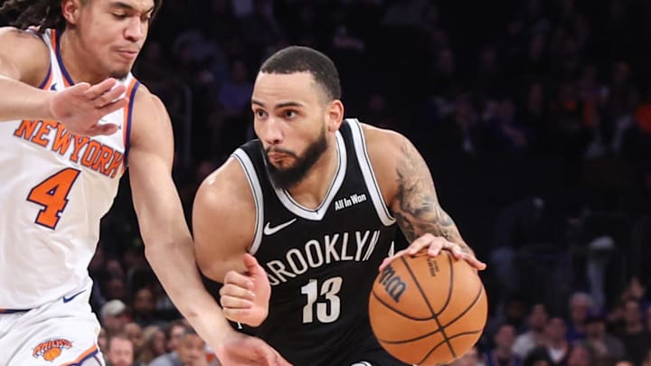 Nov 9, 2025; New York, New York, USA;  Brooklyn Nets guard Tyrese Martin (13) drives past New York Knicks forward Pacome Dadiet (4) in the fourth quarter at Madison Square Garden. Mandatory Credit: Wendell Cruz-Imagn Images