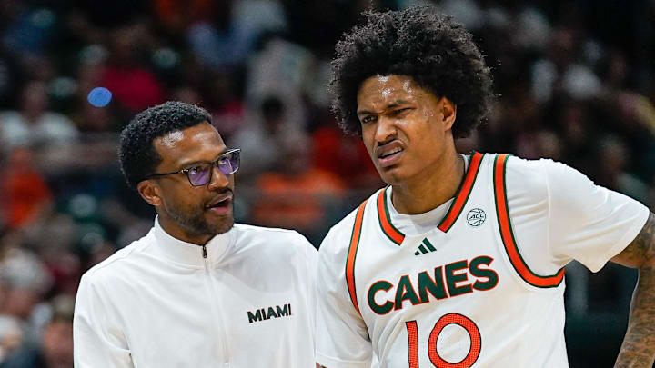 Mar 7, 2026; Coral Gables, Florida, USA; Miami Hurricanes head coach Jai Lucas talks to guard Tru Washington (10) after a foul against the Louisville Cardinals during the second half at Watsco Center. Mandatory Credit: Jeff Romance-Imagn Images