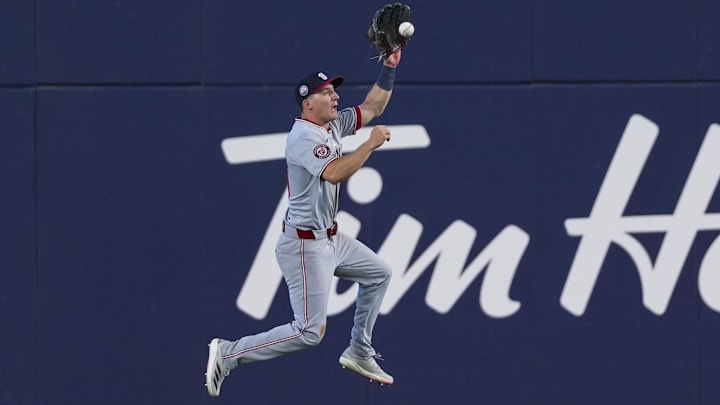 Mar 31, 2025; Toronto, Ontario, CAN; Washington Nationals outfielder Jacob Young (30) fields the ball against the Toronto Blue Jays during the eighth inning at Rogers Centre. 