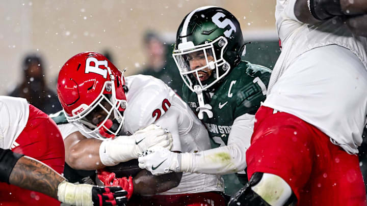 Michigan State's Nikai Martinez, right, tackles Rutgers' Ja'shon Benjamin during the fourth quarter on Saturday, Nov. 30, 2024, at Spartan Stadium in East Lansing.