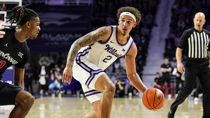 Dec 30, 2024; Manhattan, Kansas, USA; Kansas State Wildcats guard Max Jones (2) dribbles the ball against Cincinnati Bearcats guard Jizzle James (2) during the second half at Bramlage Coliseum. Mandatory Credit: Jay Biggerstaff-Imagn Images Dec 30, 2024; Manhattan, Kansas, USA; Kansas State Wildcats guard Max Jones (2) dribbles the ball against Cincinnati Bearcats guard Jizzle James (2) during the second half at Bramlage Coliseum. Mandatory Credit: Jay Biggerstaff-Imagn Images