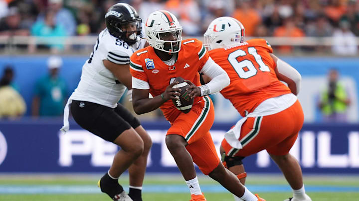 Dec 28, 2024; Orlando, FL, USA; Miami Hurricanes quarterback Cam Ward (1) scrambles with the ball against the Iowa State Cyclones during the first half at Camping World Stadium. Mandatory Credit: Jasen Vinlove-Imagn Images