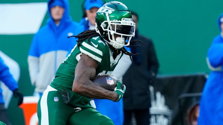 New York Jets wide receiver Allen Lazard (10) takes care of Los Angeles Rams cornerback Ahkello Witherspoon (4) as New York Jets wide receiver Davante Adams (17) continues with the ball after completing a pass for a first down in the second quarter, Sunday, December 22, 2024, in East Rutherford.