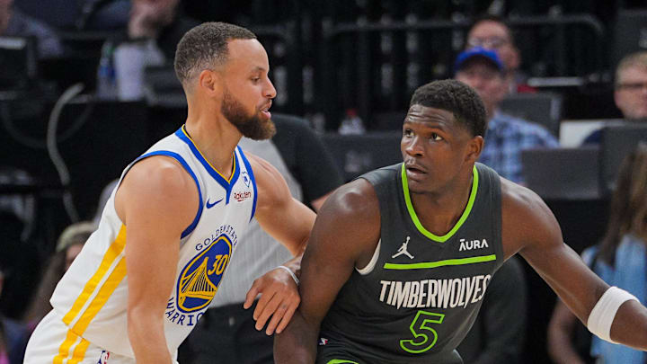 Mar 24, 2024; Minneapolis, Minnesota, USA; Golden State Warriors guard Stephen Curry (30) defends Minnesota Timberwolves guard Anthony Edwards (5) in the third quarter at Target Center. Mandatory Credit: Brad Rempel-Imagn Images
