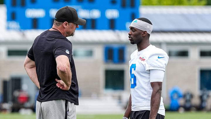 Former Detroit Lions cornerback Terrion Arnold speaks with Dan Campbell after practice