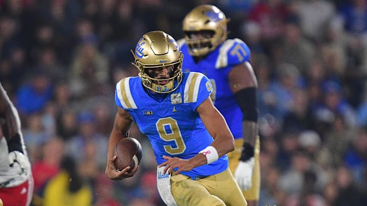 Nov 8, 2025; Pasadena, California, USA; UCLA Bruins quarterback Nico Iamaleava (9) runs the ball ahead of Nebraska Cornhuskers linebacker Dylan Rogers (52) during the first half at the Rose Bowl. Mandatory Credit: Gary A. Vasquez-Imagn Images