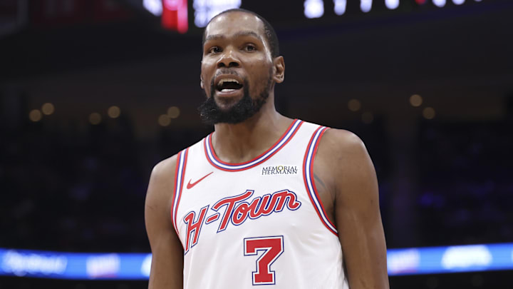 Houston Rockets forward Kevin Durant reacts with a fan in the crowd against the Milwaukee Bucks.