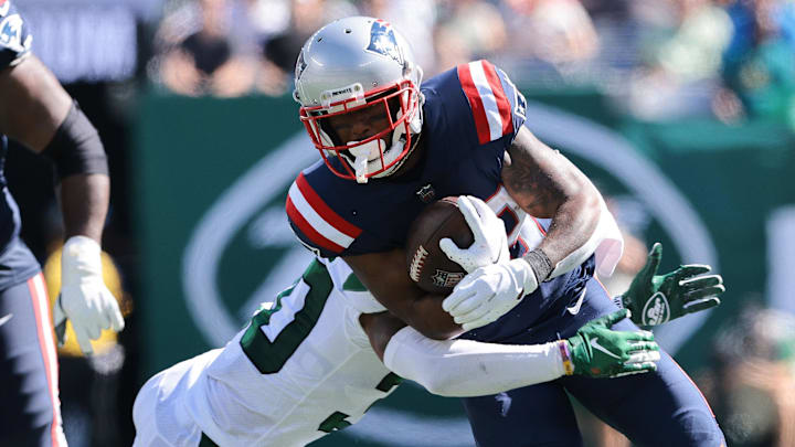 Sep 19, 2021; East Rutherford, New Jersey, USA; New England Patriots running back James White (28) carries the ball as New York Jets cornerback Michael Carter II (30) tackles during the first half at MetLife Stadium. Mandatory Credit: Vincent Carchietta-Imagn Images