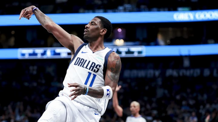 Feb 27, 2025; Dallas, Texas, USA; Dallas Mavericks guard Kyrie Irving (11) reacts after shooting against the Charlotte Hornets during the second half at American Airlines Center.