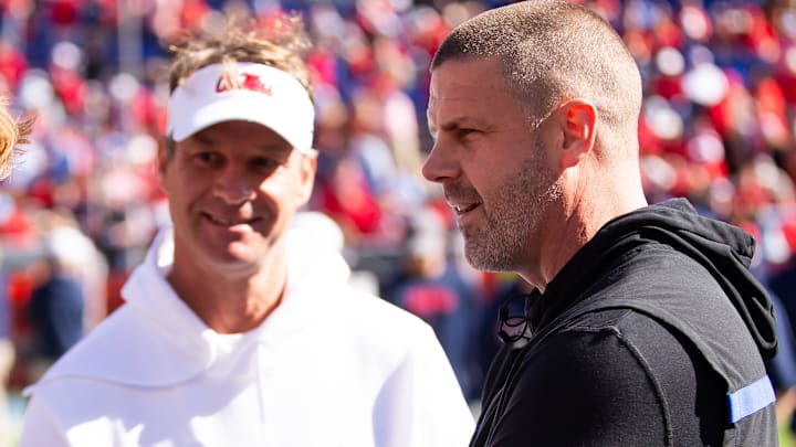 Florida Gators head coach Billy Napier talks with Mississippi Rebels head coach Lane Kiffin before the start of the game at Ben Hill Griffin Stadium in Gainesville, FL on Saturday, November 23, 2024. [Doug Engle/Gainesville Sun]