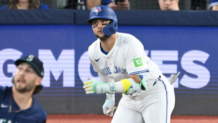 Apr 19, 2025; Toronto, Ontario, CAN;  Toronto Blue Jays shortstop Bo Bichette (11) hits an RBI single off Seattle Mariners pitch Collin Snider (52) in the sixth inning at Rogers Centre. 