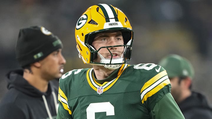 With Jordan Love in the background, Clayton Tune warms up before last week's Packers-Ravens game.