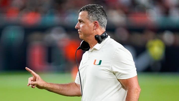 Nov 8, 2025; Miami Gardens, Florida, USA; Miami Hurricanes head coach Mario Cristobal gives his team instructions against the Syracuse Orange during the third quarter at Hard Rock Stadium. Mandatory Credit: Jeff Romance-Imagn Images