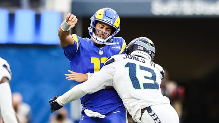 Jan 5, 2025; Inglewood, California, USA;  Seattle Seahawks cornerback Stetson Bennett (13) tackles Los Angeles Rams Quarterback Jimmy Garoppolo (11) during the 2nd quarter drive at SoFi Stadium. Mandatory Credit: William Navarro-Imagn Images