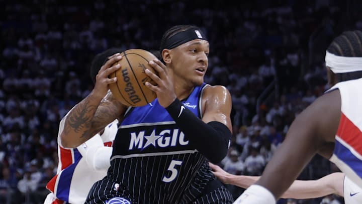 Apr 19, 2026; Detroit, Michigan, USA; Orlando Magic forward Paolo Banchero (5) dribbles defended by Detroit Pistons guard Caris LeVert (8) in the second half during the 2026 NBA Playoffs at Little Caesars Arena. Mandatory Credit: Rick Osentoski-Imagn Images