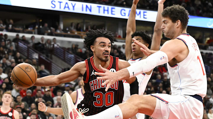Jan 20, 2026; Chicago, Illinois, USA; Chicago Bulls guard Tre Jones (30) passes the ball away from LA Clippers center Brook Lopez (11) and guard Tyty Washington Jr. (14) during the second half at United Center. Mandatory Credit: Matt Marton-Imagn Images Jan 20, 2026; Chicago, Illinois, USA; Chicago Bulls guard Tre Jones (30) passes the ball away from LA Clippers center Brook Lopez (11) and guard Tyty Washington Jr. (14) during the second half at United Center. Mandatory Credit: Matt Marton-Imagn Images
