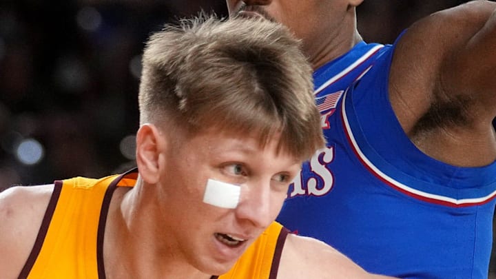 ASU Sun Devils guard Noah Meeusen (15) drives past Kansas Jayhawks guard Bryson Tiller (15) at Desert Financial Arena in Tempe on March 3, 2026.