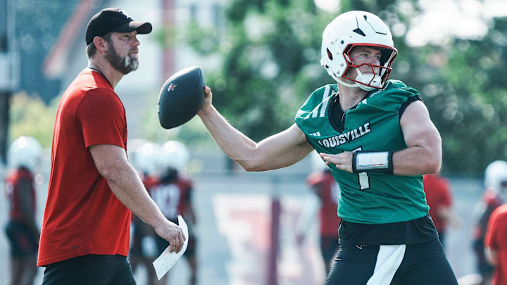 Louisville Cardinals quarterback Miller Moss during a morning practice Wednesday, July 30, 2025. Moss transferred from USC. His overall QB rating is 81.4. At left is UofL quarterbacks coach and offensive coordinator Brian Brohm. Louisville Cardinals quarterback Miller Moss during a morning practice Wednesday, July 30, 2025. Moss transferred from USC. His overall QB rating is 81.4. At left is UofL quarterbacks coach and offensive coordinator Brian Brohm.