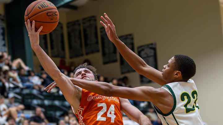 Orangefield’s Jayden Scales rises for the layup through a physical East Chambers defender 