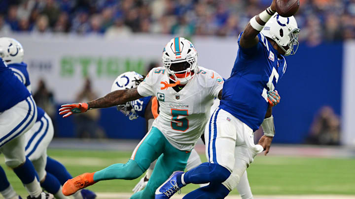 Oct 20, 2024; Indianapolis, Indiana, USA; Miami Dolphins cornerback Jalen Ramsey (5) gets a hand on Indianapolis Colts quarterback Anthony Richardson (5) during the second quarter at Lucas Oil Stadium. Mandatory Credit: Marc Lebryk-Imagn Images