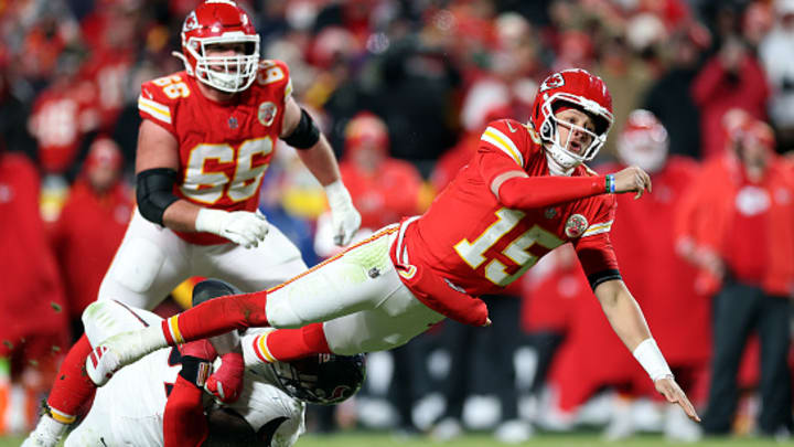 Kansas City Chiefs quarterback Patrick Mahomes falls as he throws a touchdown pass to Travis Kelce.