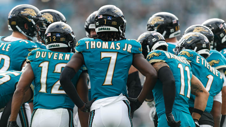 Dec 15, 2024; Jacksonville, Florida, USA; Jacksonville Jaguars wide receiver Brian Thomas Jr. (7), wide receiver Devin Duvernay (12), wide receiver Parker Washington (11), running back Travis Etienne Jr. (1) and the offense huddle against the New York Jets during the second quarter at EverBank Stadium. Mandatory Credit: Morgan Tencza-Imagn Images