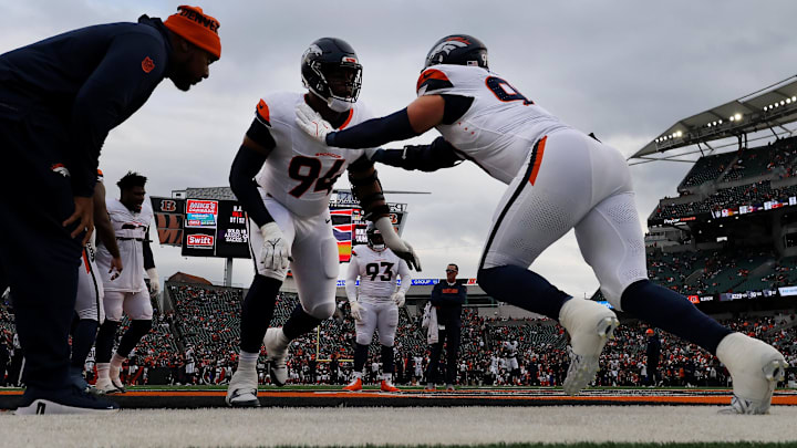 Dec 28, 2024; Cincinnati, Ohio, USA;  Denver Broncos defensive tackle Jordan Jackson (94) and defensive end Zach Allen (99) warm up before a game against the Cincinnati Bengals at Paycor Stadium. 
